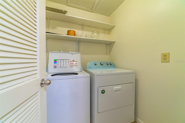 clothes washing area with washing machine and dryer