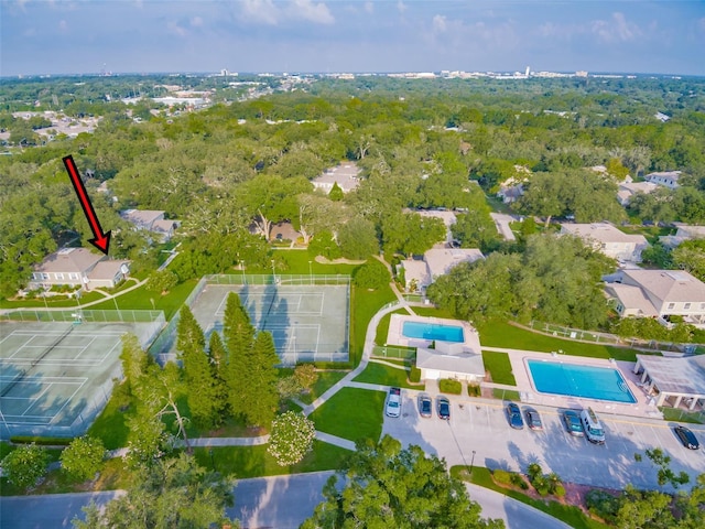 drone / aerial view with a wooded view