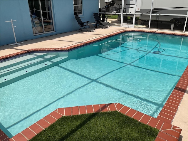 view of swimming pool featuring a patio area