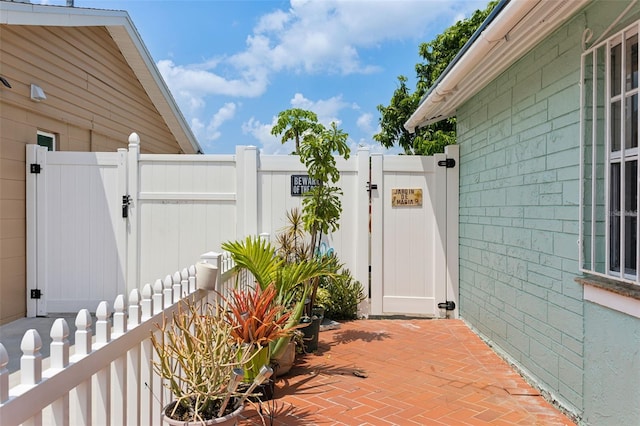 exterior space featuring a patio area, a gate, and fence