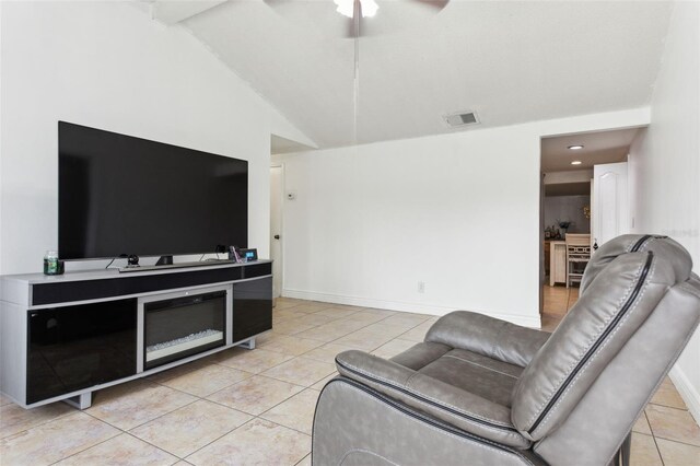 living room with ceiling fan, lofted ceiling, and light tile patterned floors