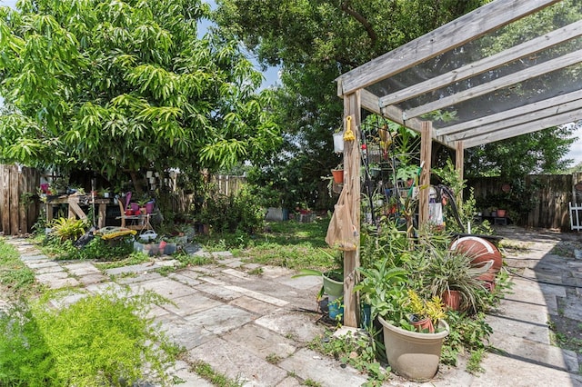 view of yard featuring a fenced backyard, a pergola, and a patio