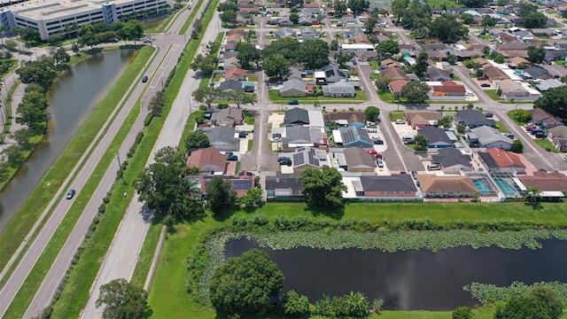 drone / aerial view with a water view and a residential view