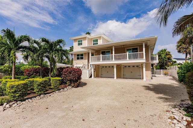 210 Lakeview Dr, Anna Maria, FL 34216 - coastal inspired home with fence, an attached garage, and dirt driveway