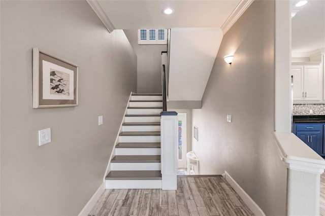 210 Lakeview Dr, Anna Maria, FL 34216 - stairway with baseboards, visible vents, crown molding, and wood finished floors
