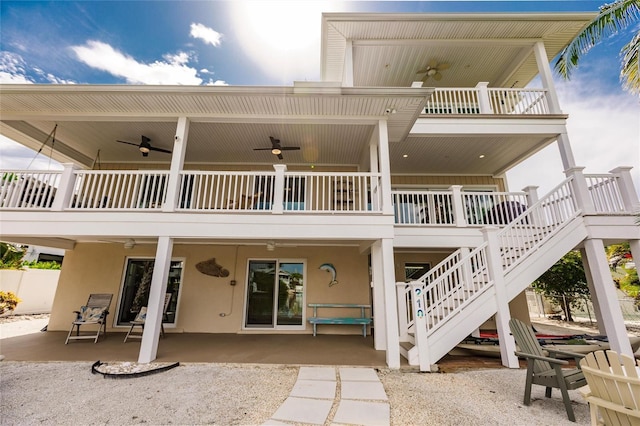 210 Lakeview Dr, Anna Maria, FL 34216 - back of house featuring stucco siding, stairs, a ceiling fan, and a patio area