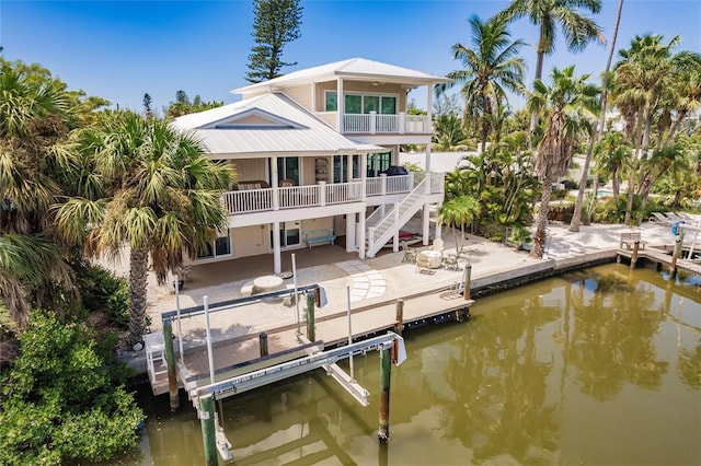 210 Lakeview Dr, Anna Maria, FL 34216 - exterior space with a balcony, a water view, a patio, stairs, and boat lift