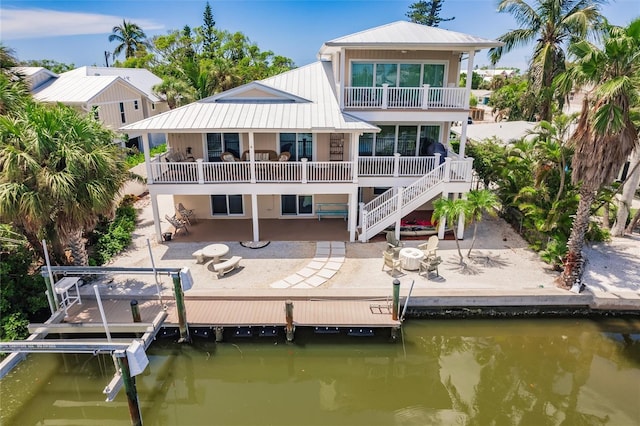 210 Lakeview Dr, Anna Maria, FL 34216 - rear view of property featuring a balcony, a water view, and a patio area