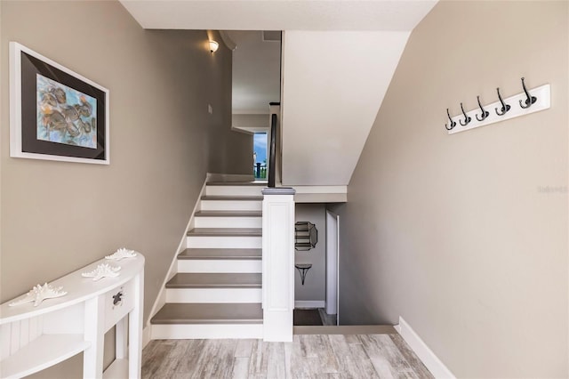 210 Lakeview Dr, Anna Maria, FL 34216 - stairs with baseboards and wood finished floors