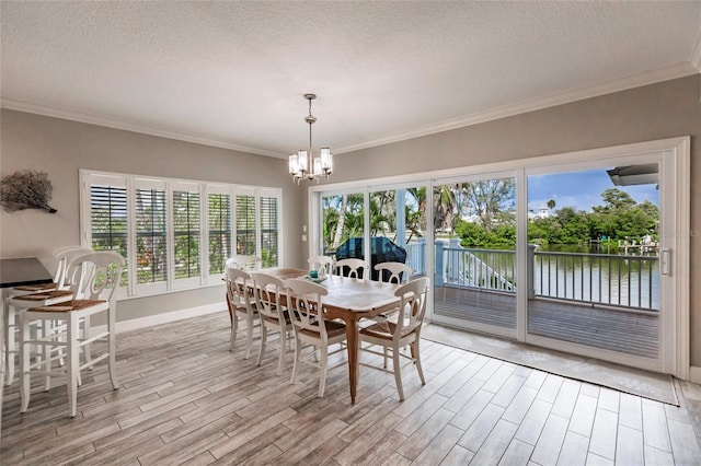 210 Lakeview Dr, Anna Maria, FL 34216 - dining room with a textured ceiling, light wood-style floors, ornamental molding, and an inviting chandelier