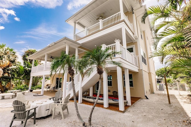 210 Lakeview Dr, Anna Maria, FL 34216 - view of side of property featuring stairs, stucco siding, fence, a patio, and ceiling fan