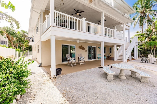 210 Lakeview Dr, Anna Maria, FL 34216 - back of house with fence, stairs, ceiling fan, stucco siding, and a patio area