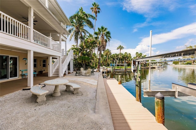 210 Lakeview Dr, Anna Maria, FL 34216 - dock area with a water view, stairs, and a patio area
