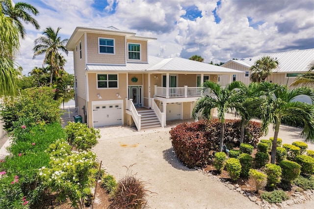 210 Lakeview Dr, Anna Maria, FL 34216 - beach home featuring stairs, a garage, and concrete driveway