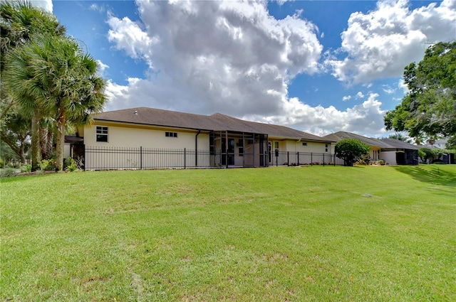 back of property featuring a yard