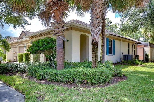 view of property exterior with a yard and central AC unit