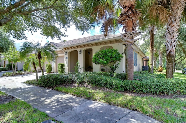 mediterranean / spanish-style house with a garage