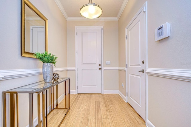 doorway with light wood-type flooring and ornamental molding