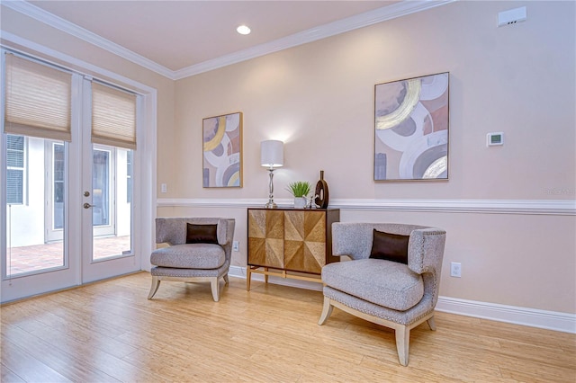 living area with french doors, light hardwood / wood-style floors, and ornamental molding