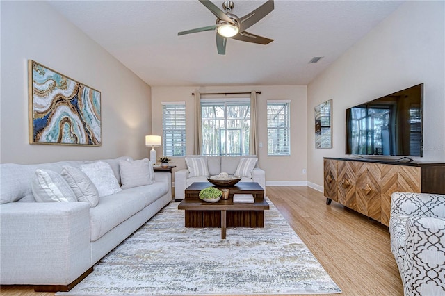 living room featuring ceiling fan and light wood-type flooring