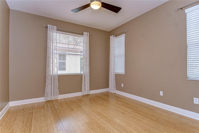 empty room with ceiling fan and light wood-type flooring