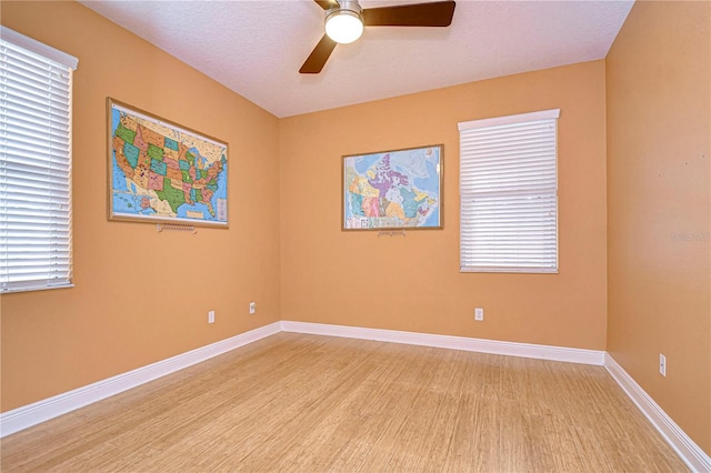 unfurnished room featuring a textured ceiling, light hardwood / wood-style floors, and ceiling fan