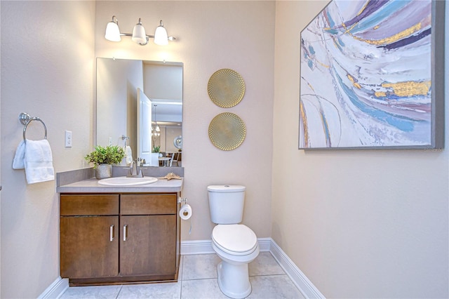 bathroom featuring tile patterned floors, vanity, and toilet