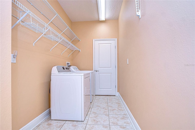 laundry area featuring separate washer and dryer and light tile patterned flooring