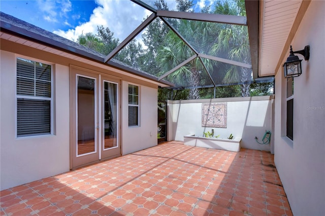 view of patio / terrace featuring glass enclosure and french doors