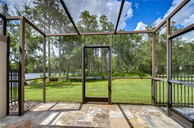 unfurnished sunroom with a water view