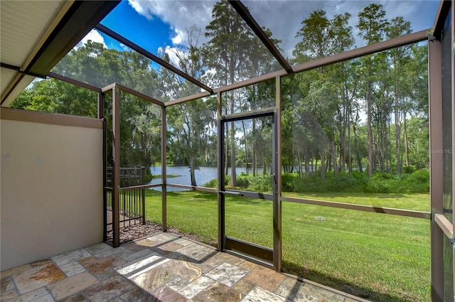 unfurnished sunroom with a water view