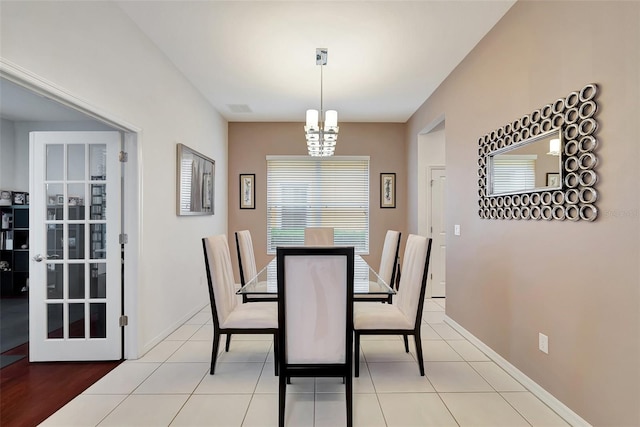 tiled dining area with a chandelier