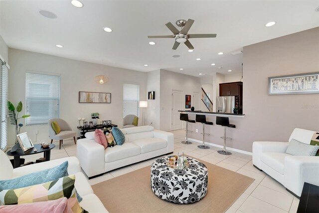 living room with ceiling fan and light tile patterned floors