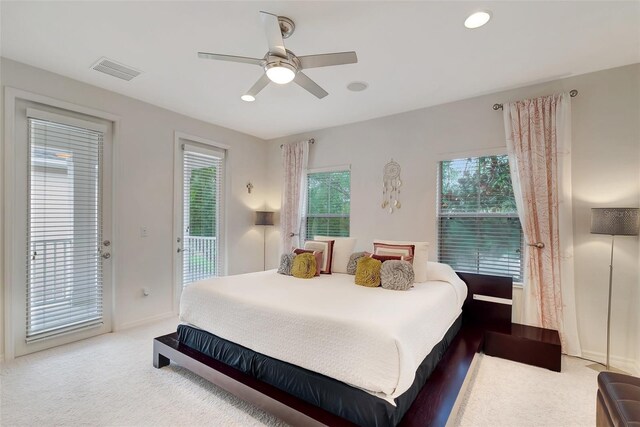 bedroom featuring light carpet, access to outside, and ceiling fan