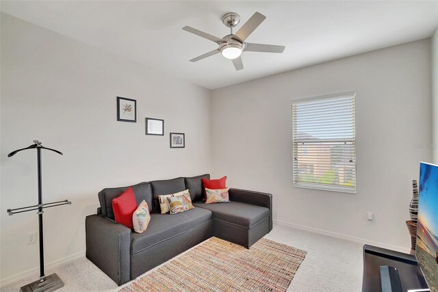 carpeted living room with ceiling fan