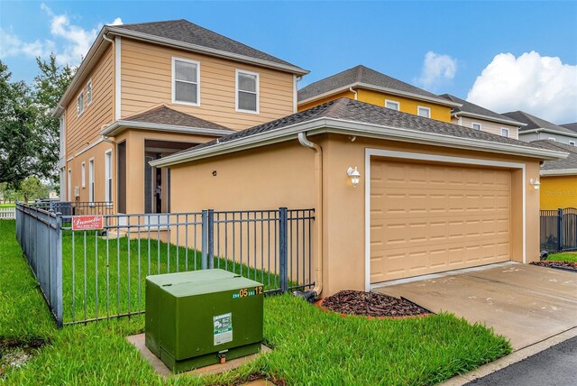 view of front of house with a front yard and a garage