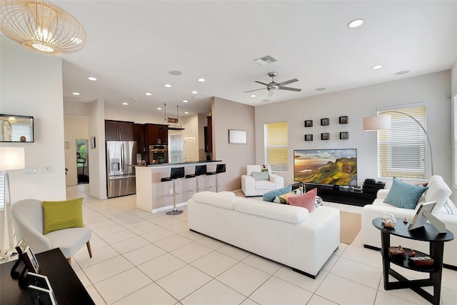 tiled living room featuring ceiling fan