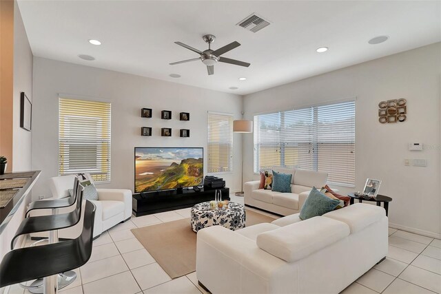 living area featuring a ceiling fan, visible vents, recessed lighting, and light tile patterned flooring