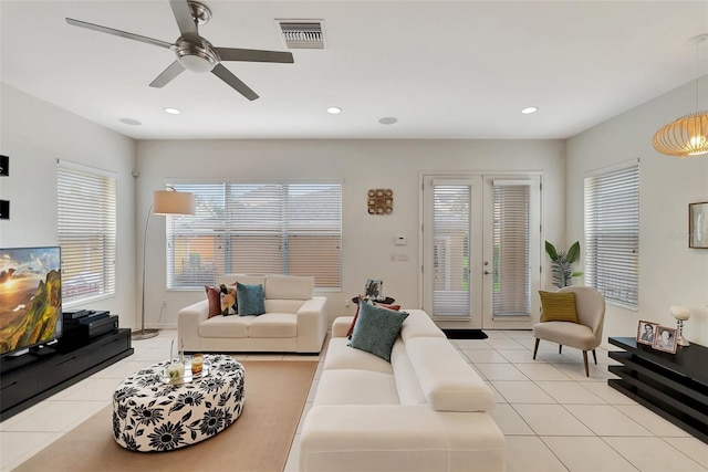 living room with french doors, ceiling fan, and light tile patterned floors