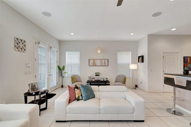 living room featuring recessed lighting, a wealth of natural light, baseboards, and light tile patterned floors