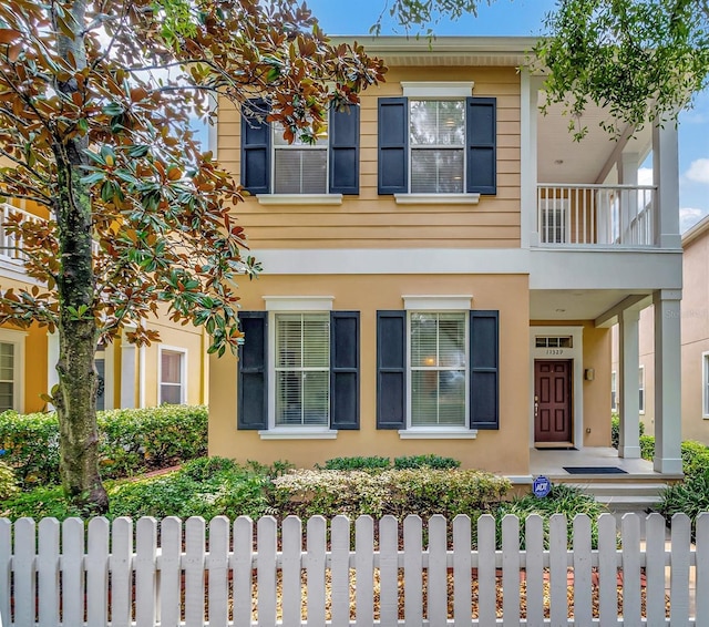 11329 Emerson Lake Dr, Riverview, FL 33578 - multi unit property with a fenced front yard, a balcony, and stucco siding