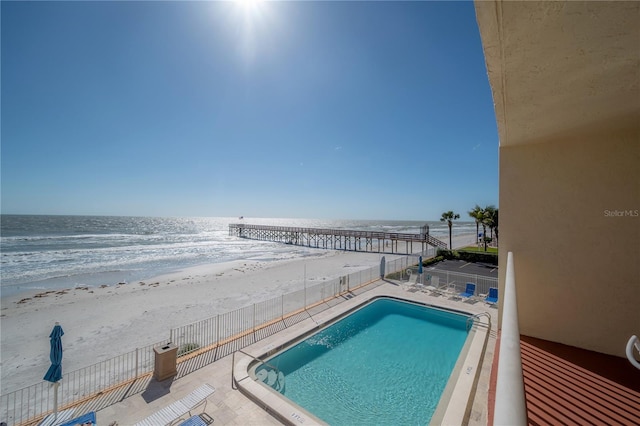 view of swimming pool with a water view