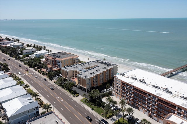 drone / aerial view featuring a water view and a view of the beach