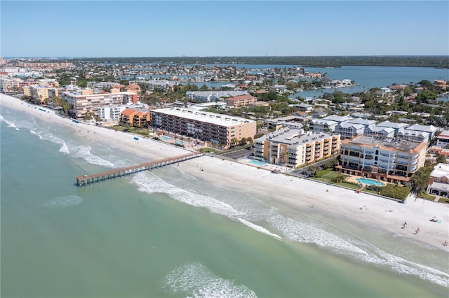 birds eye view of property with a water view and a beach view