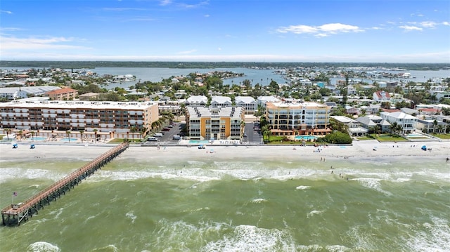 birds eye view of property featuring a water view and a beach view