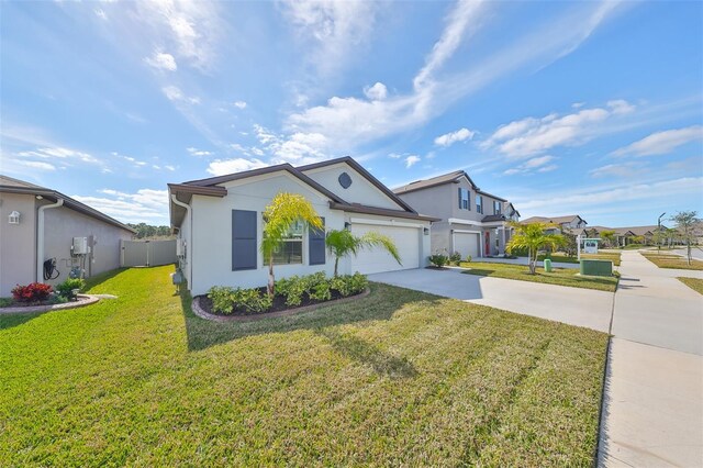 view of front of property featuring a front lawn and a garage