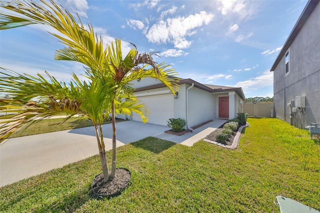 view of side of property with a yard and a garage