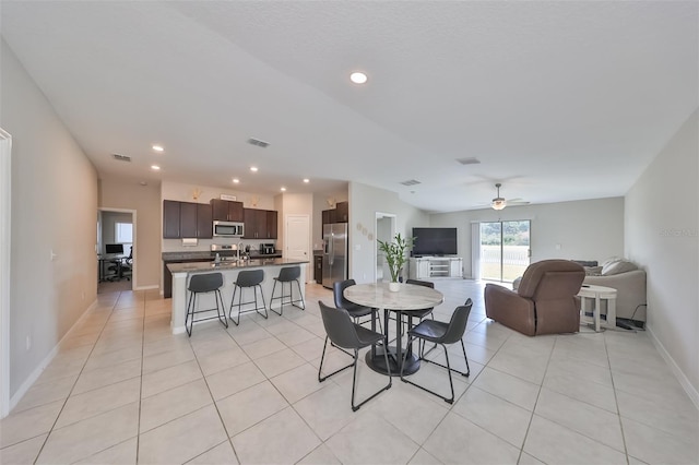 dining area with light tile patterned floors and ceiling fan