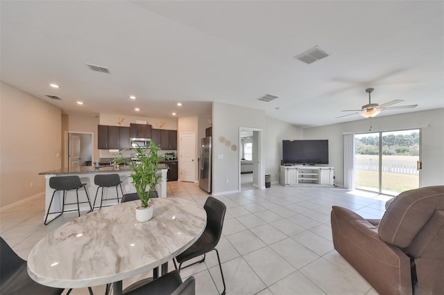 tiled dining space featuring ceiling fan