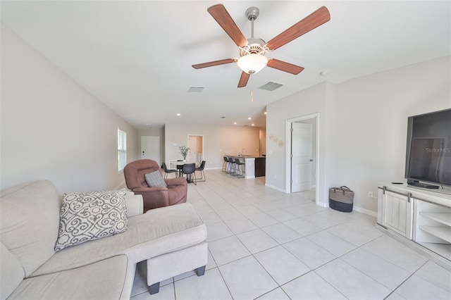 living room with light tile patterned floors and ceiling fan